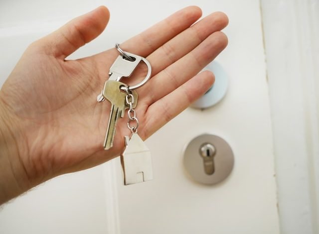 home key in person's hand