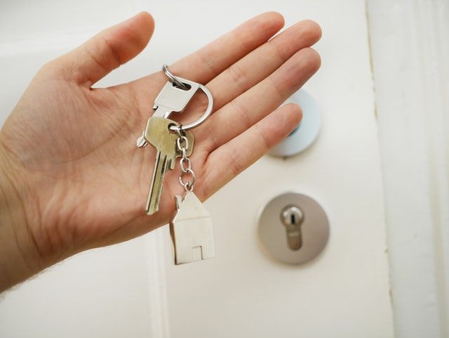 home key in person's hand